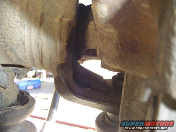 Close-up of rusty vehicle suspension parts, possibly a ball joint assembly