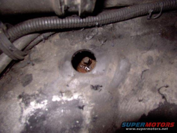 img_0077.jpg Enough of that crouch and reach nonsense !  We Mopar types are used to access from above !  Anything that'll drill through wood will drill nicely through plastic (and did).