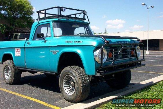 Turquoise Dodge pickup truck with roof rack and bull bar