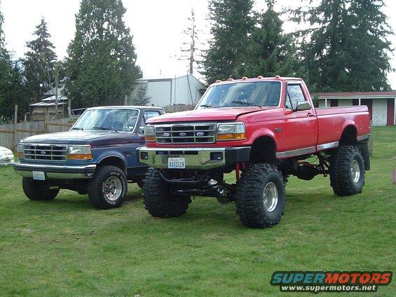 Big Red next to my previous truck, a stock '92 F-250 on 33's.