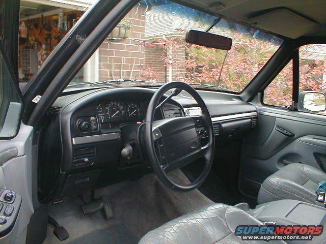1994 Ford Bronco interior with gray leather seats and dashboard