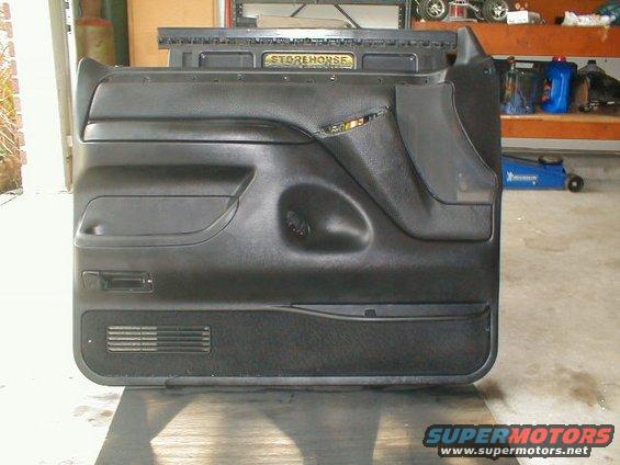 Black interior door panel with storage pockets and speaker grille. A "STOREHOUSE" label is visible at the top