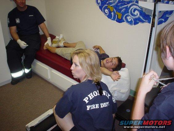 Fire department personnel attend to a patient on a medical cot