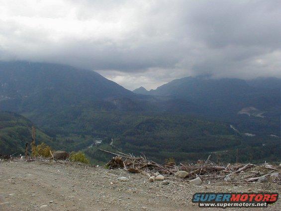 Mountainous landscape with a cloudy sky and debris in the foreground