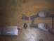 1991 Ford Crown Victoria - Disassembled exhaust system components laid out on a textured surface.