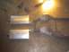1991 Ford Crown Victoria - Exhaust system components, including mufflers and catalytic converters, laid out on a concrete floor.