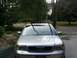1999 Audi A6 - The front of a silver 1999 Audi A6 is visible, parked outdoors with trees and a house in the background.