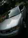 1999 Audi A6 - A silver Audi sedan is parked in a driveway with trees and foliage visible.