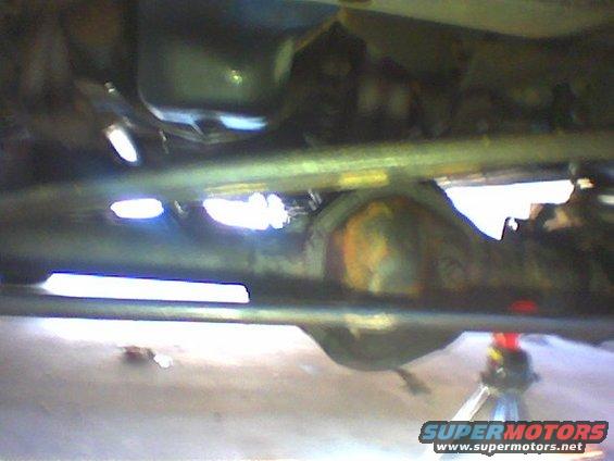 Undercarriage view of vehicle differential and suspension components