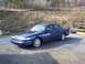 1995 Ford Crown Victoria - A blue sedan is parked outdoors with a snowplow and another vehicle visible in the background.