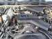 1995 Ford Crown Victoria - Close-up view of a V8 engine with an OVERHEAD CAM cover, showing various hoses and wiring. The image includes a watermark for SUPERMOTORS.