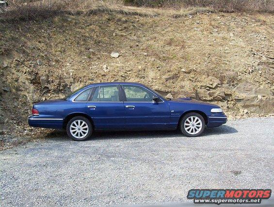 1995 Ford Crown Victoria parked on gravel, side view