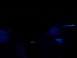 1995 Ford Crown Victoria - A blue Ford emblem is visible on a dark surface, with some green lights in the background.