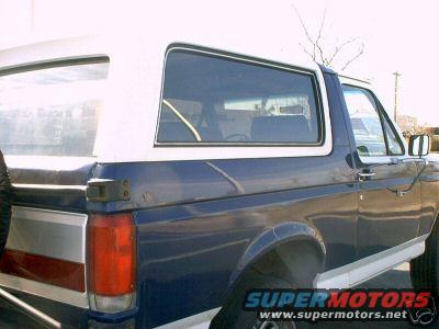 1987 Ford Bronco, blue and white, side view showing rear quarter panel and passenger door