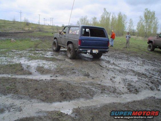 Blue 1981 Ford Bronco in mud, rear view