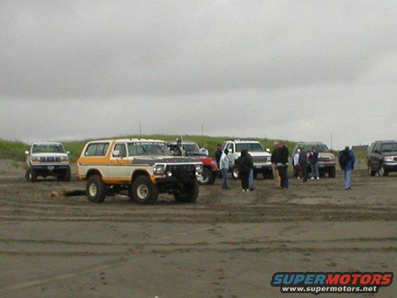 1978 Ford Bronco with yellow and white paint on a sandy beach