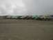 1978 Ford Bronco - A group of off-road vehicles are lined up on the sand, ready for a day of beach driving.