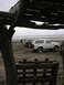 1978 Ford Bronco - Several SUVs are parked on a sandy beach, with the ocean in the background.