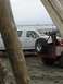 1978 Ford Bronco - Two vehicles are parked on a sandy beach with the ocean in the background.