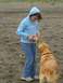 1978 Ford Bronco - A young girl offers a treat to her dog on a cloudy day at the beach.