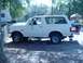 1989 Ford Bronco - This white 1989 Ford Bronco is shown from the side, a spare tire mounted on the rear.