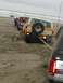 1978 Ford Bronco - Several vehicles are stuck in the sand on a beach, with one Bronco being towed.