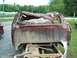 1990 Ford F-150 - Rear view of a heavily damaged 1990 Ford F-150 pickup truck, showing significant body deformation.
