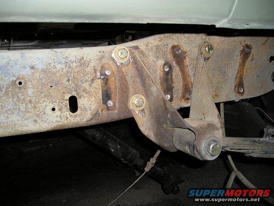 Rusted frame section with suspension parts and SuperMotors.net logo