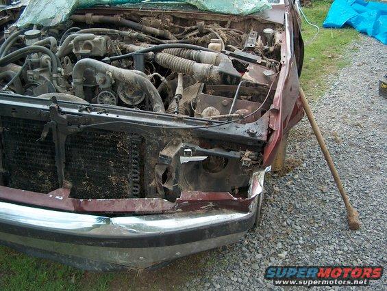 1990 Ford F-150 engine bay showing damage, front end missing headlight and grille