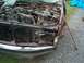 1990 Ford F-150 - Front view of a damaged 1990 Ford F-150 with its engine exposed and hood missing.
