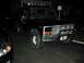 1985 Ford Bronco - A black Ford Bronco is parked in a driveway at night, illuminated by exterior lights.