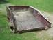 1990 Ford F-150 - A damaged truck bed sits on grass, showing significant wear and tear on its rear sections.