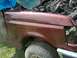 1990 Ford F-150 - The front fender and engine of a maroon 1990 Ford F-150 are visible in this damaged vehicle photo.