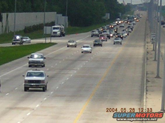 Highway traffic with a white pickup truck in the foreground