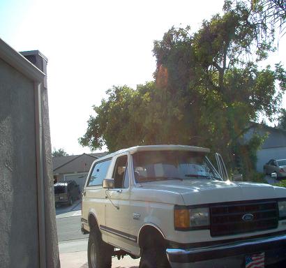 White 1988 Ford Bronco with driver's door open