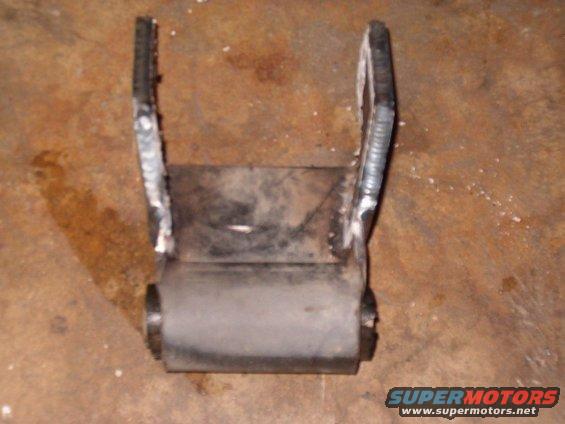 Suspension shackle part with rubber bushing and welded metal brackets