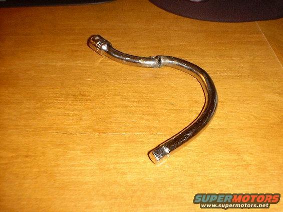 Chrome-plated metal tool with a hexagonal socket on one end and a bent shaft