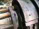 1986 Ford Bronco - This is a close-up view of a vehicle's brake drum and shoes, showing signs of grease and wear.