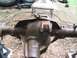 1986 Ford Bronco - Close-up of a rusty rear axle differential housing, likely removed from a vehicle for repair or replacement.
