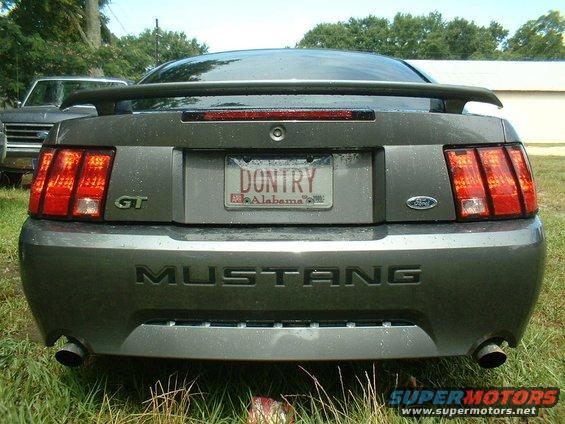 Rear view of a gray 2003 Ford Mustang GT with a spoiler and custom license plate