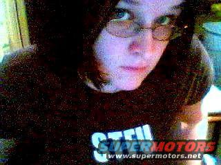 Person wearing glasses and a dark t-shirt with text