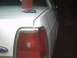 1991 Ford Crown Victoria - Rear view of a 1991 Ford Crown Victoria, showing the trunk lid with items on it.