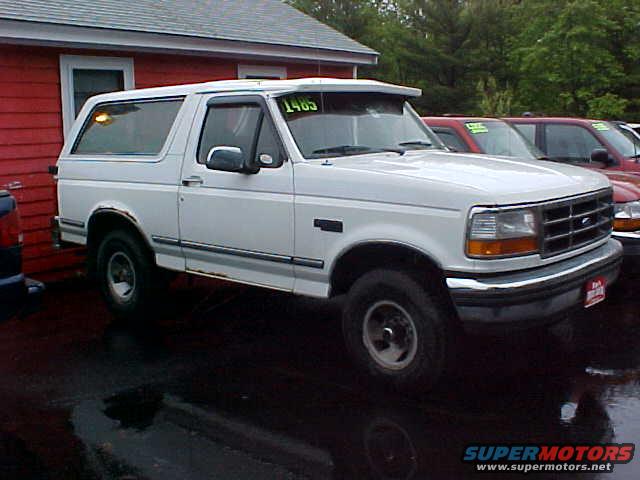 White 1995 Ford Bronco 3/4 front view with a visor displaying '1995'