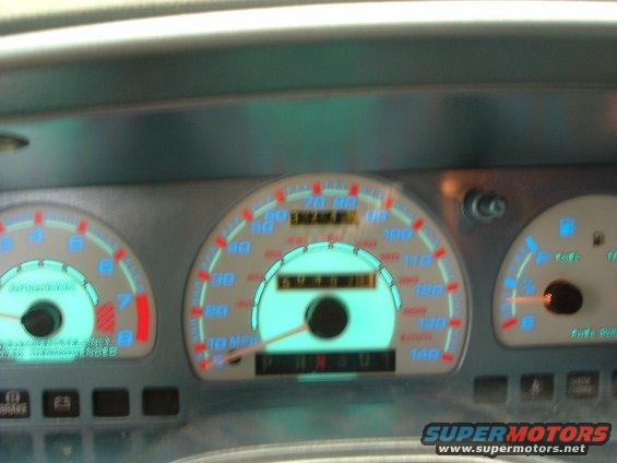 Car dashboard with speedometer, tachometer, and fuel gauge. Odometer reads 67371