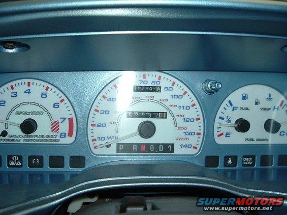 Dashboard gauges with tachometer, speedometer, fuel, and temperature gauges. Odometer reads 504921