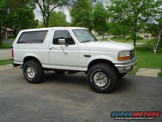 White lifted Ford Bronco with BFGoodrich All-Terrain T/A tires parked on asphalt
