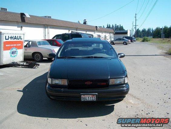 Front view of a black 1996 Chevrolet Impala with a red bowtie emblem on the grille. License plate reads 96LT1SS
