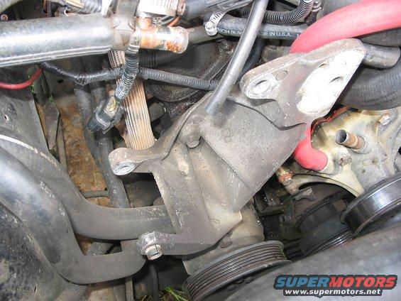 110_1021.jpg alright...old/original alternator is out.  look at all them wires!