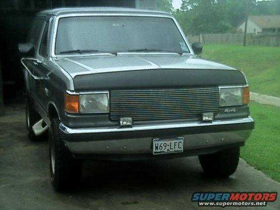Silver Ford Bronco with a chrome grille and a black hood protector
