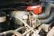 1988 Ford Bronco - This image shows a detailed view of a vehicle's engine compartment, focusing on various mechanical parts and connections.